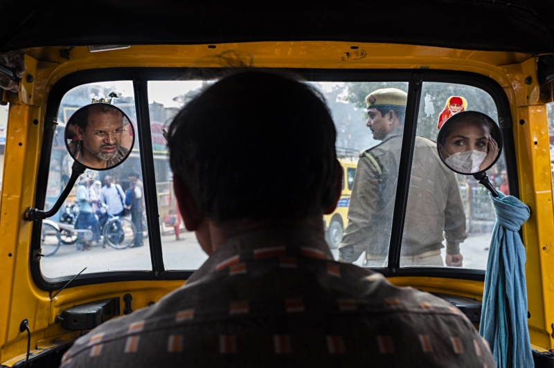Woman's face in the mirror of rickshaw